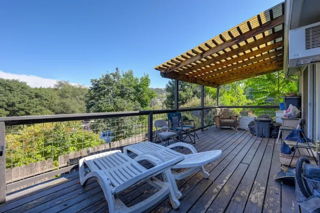 a view of balcony with wooden floor and outdoor seating
