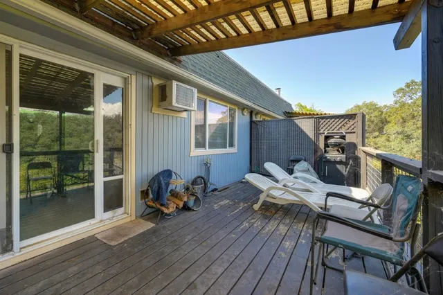 a view of a balcony with chair and wooden floor