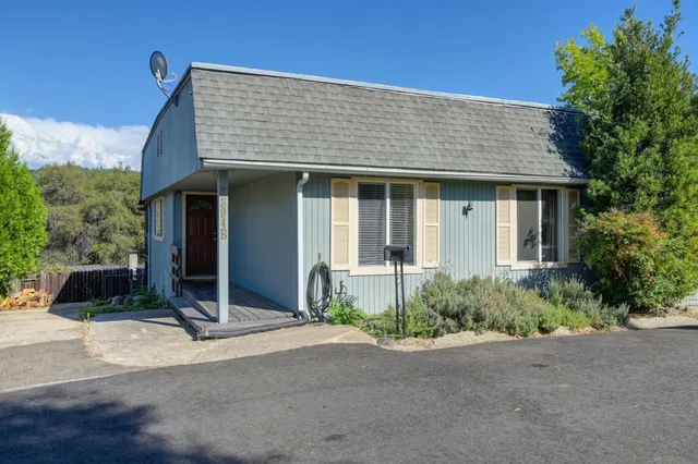 a front view of a house with a garden