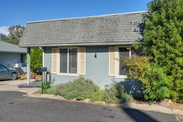 front view of a house with a bench