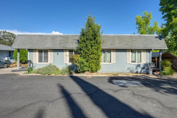 a kitchen with stainless steel appliances granite countertop a stove a refrigerator a white table and chairs