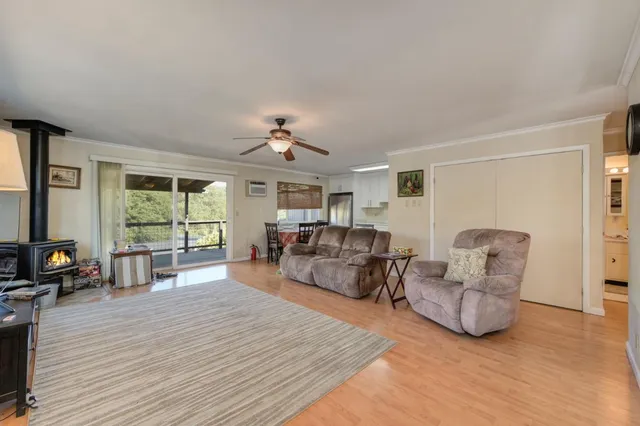 a living room with furniture a flat screen tv and a large window