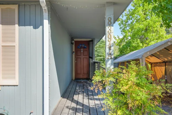 a view of a porch with wooden floor and outdoor space