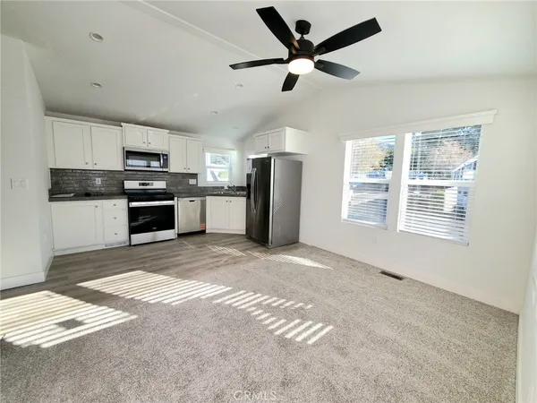 a view of a kitchen with a stove cabinets and entryway