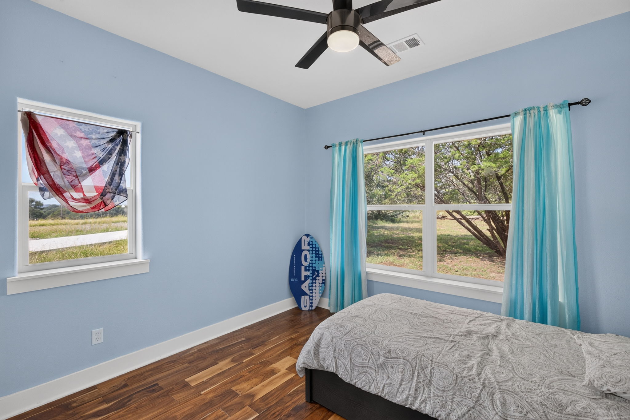 207 Deer Ridge Drive Burnet, TX 78611 - Photo 28 of 36 Ample natural light illuminates rich hardwood flooring in this cozy sleeping space.