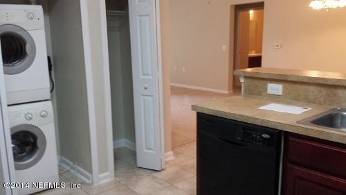 7920 Merrill Road, Unit 1407 Jacksonville, FL 32277 - Photo 3 of 7 a bathroom with a sink and a washer