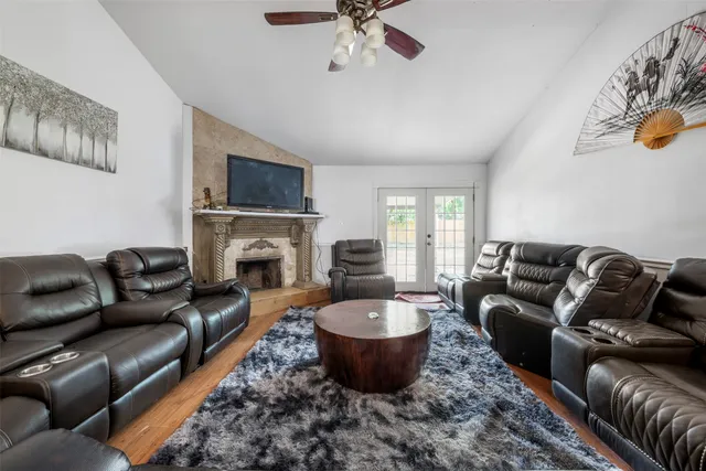 a living room with furniture a fireplace and a flat screen tv