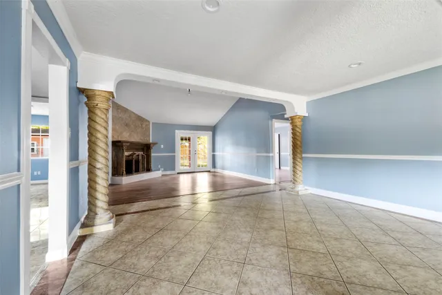 a view of an empty room with window and fire place