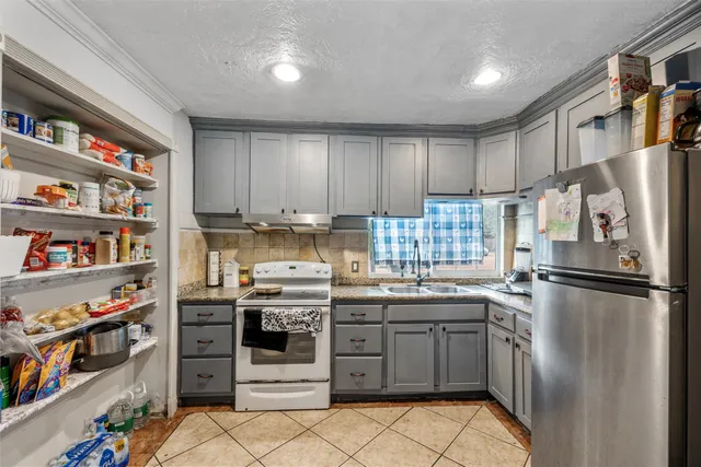 a kitchen with stainless steel appliances granite countertop a refrigerator sink and cabinets