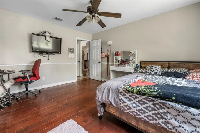 a bedroom with a bed and flat screen tv