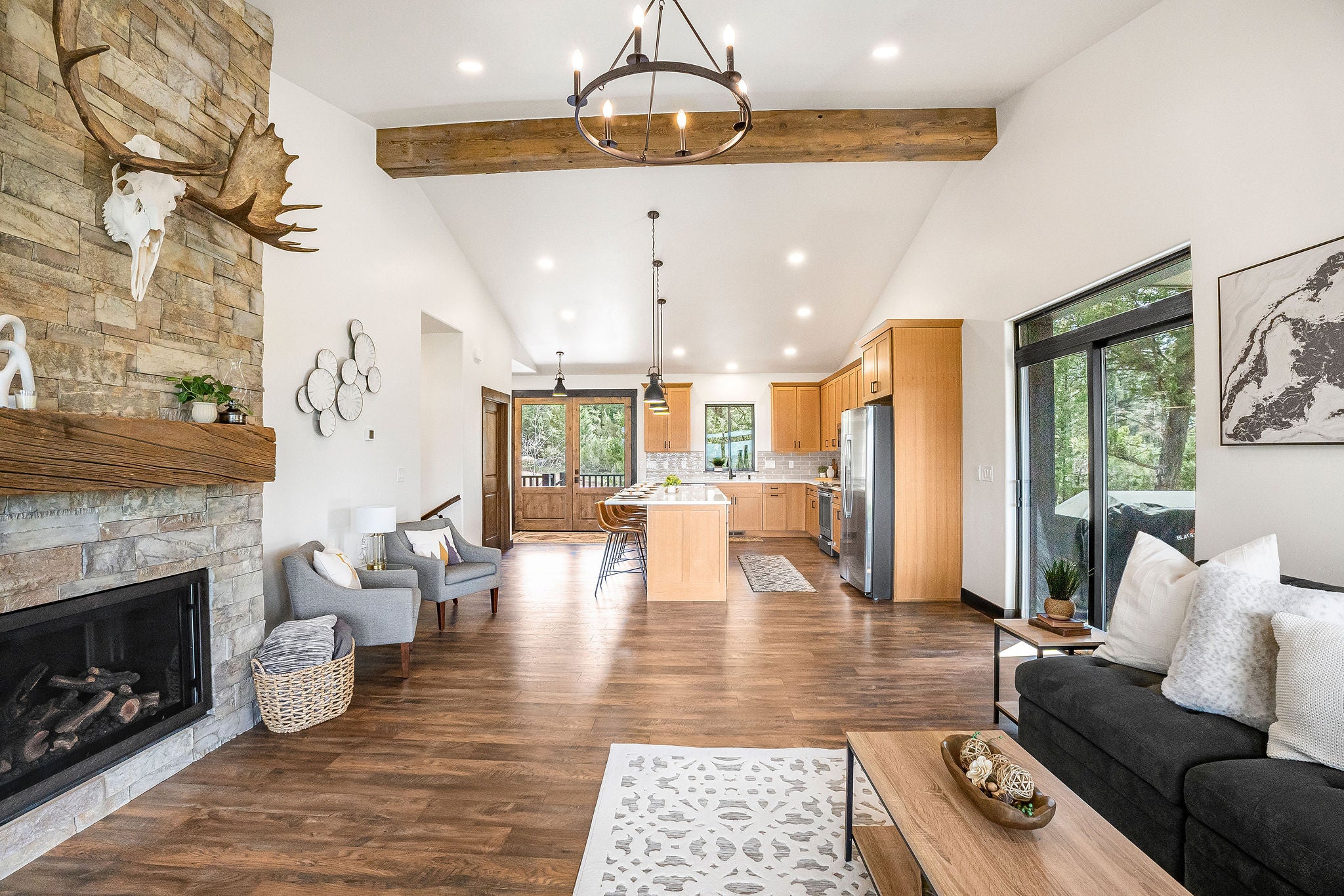 77 Rumsey Road Philipsburg, MT 59858 - Photo 22 of 76 Living room featuring a chandelier, high vaulted ceiling, healthy amount of natural light, beam ceiling, and dark wood finished floors