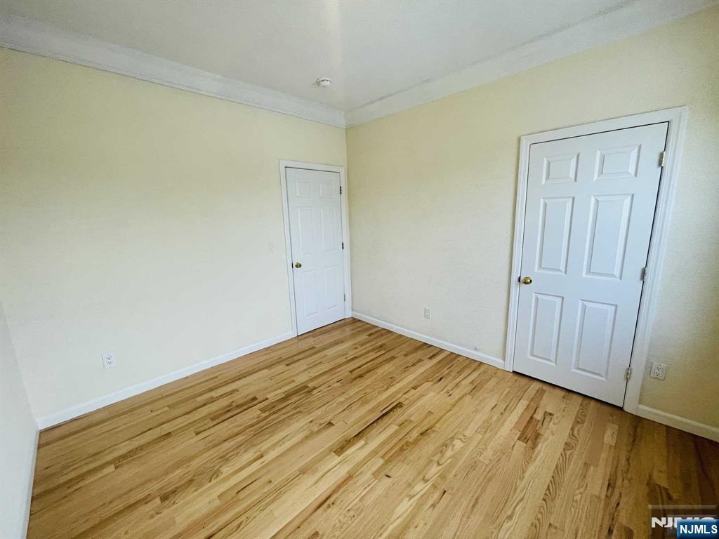 229 Orient Way, Unit 3 Rutherford, NJ 07070 - Photo 16 of 22 a view of empty room with wooden floor
