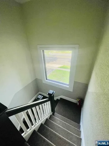 a view of a hallway with stairs