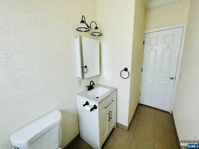 a bathroom with a toilet sink and vanity