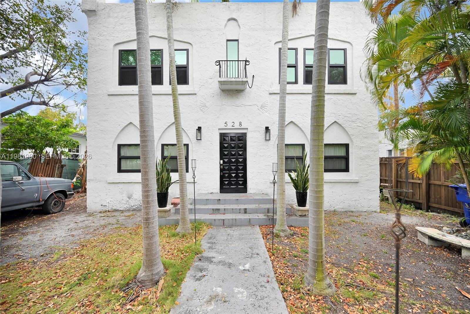 a front view of a building with parking area