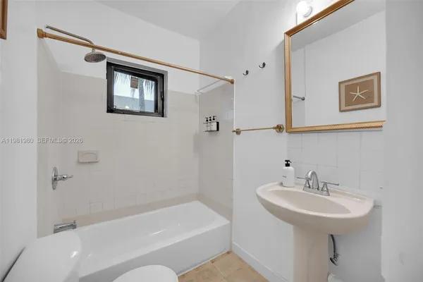 a room with pool table and window