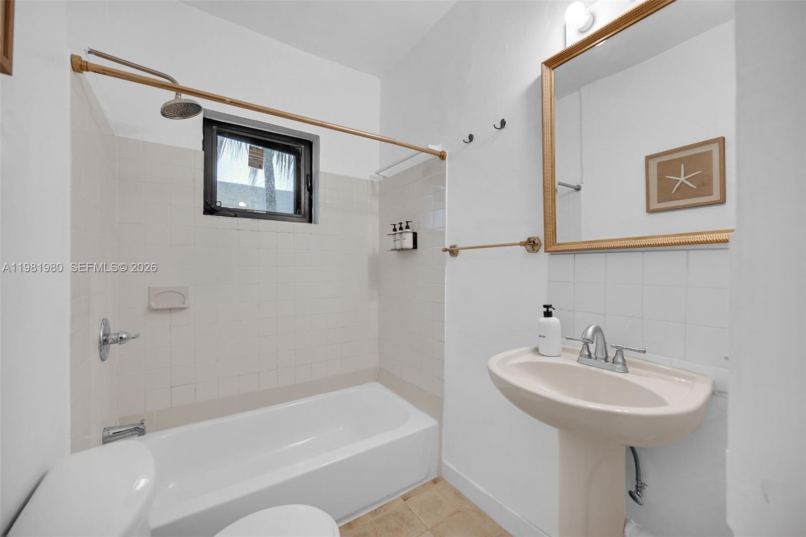 528 Northwest 47th Street, Unit 2 Miami, FL 33127 - Photo 16 of 34 a bathroom with a sink a toilet and shower