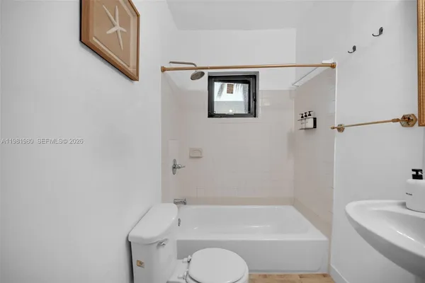 a room with pool table and window