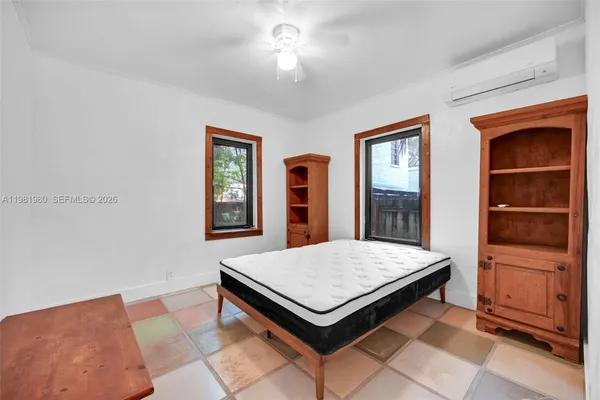 a bedroom with furniture and window