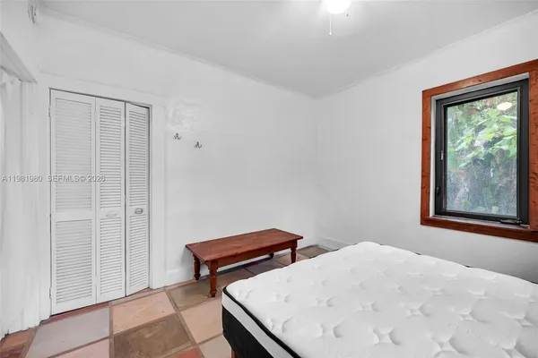 a white house that has a tree in front of it