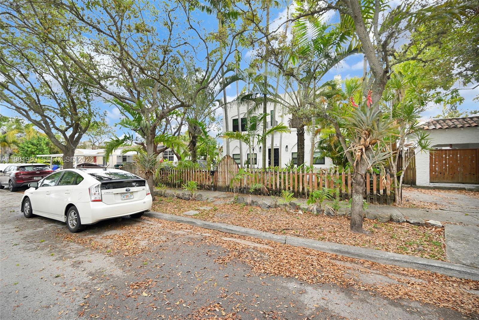 528 Northwest 47th Street, Unit 2 Miami, FL 33127 - Photo 22 of 34 a white house that has a tree in front of it