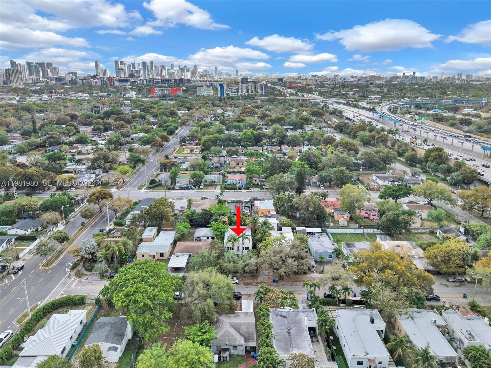 528 Northwest 47th Street, Unit 2 Miami, FL 33127 - Photo 24 of 34 an aerial view of residential houses with outdoor space and trees