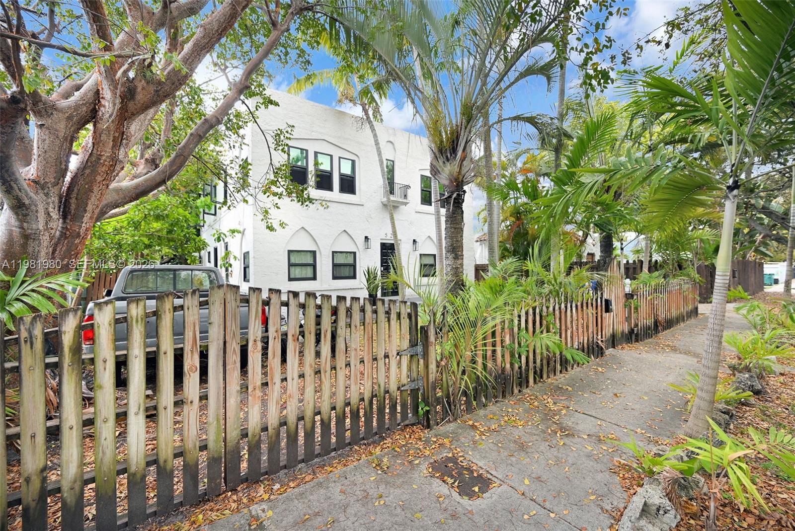 528 Northwest 47th Street, Unit 2 Miami, FL 33127 - Photo 28 of 34 a view of a white house with a large trees
