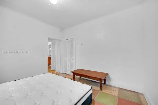 a room with pool table and wooden floor