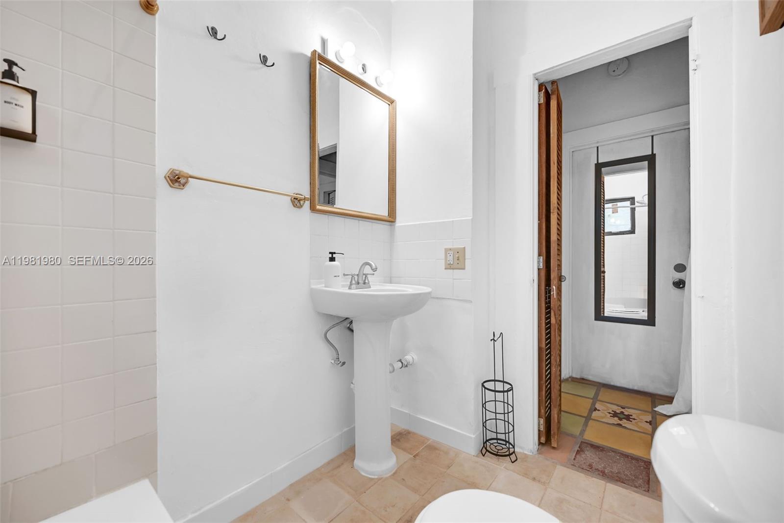 528 Northwest 47th Street, Unit 2 Miami, FL 33127 - Photo 32 of 34 a bathroom with a sink toilet and shower