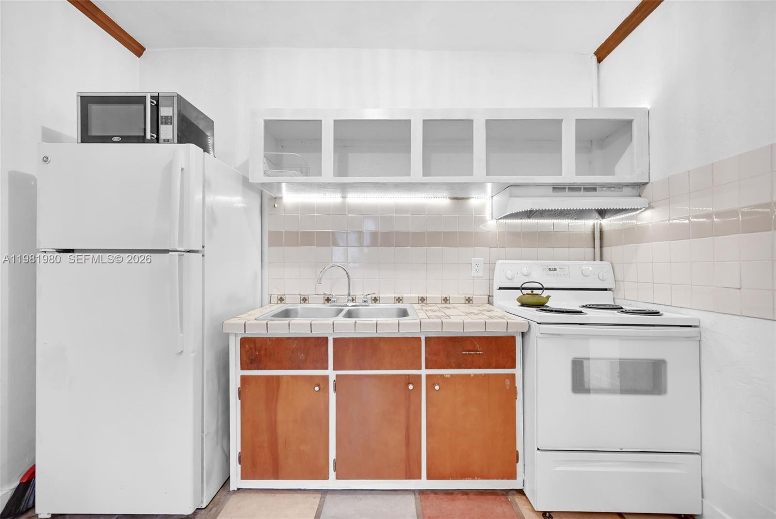 528 Northwest 47th Street, Unit 2 Miami, FL 33127 - Photo 34 of 34 a white refrigerator freezer sitting inside of a kitchen
