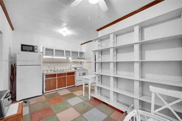 a room with cabinets and view of living room