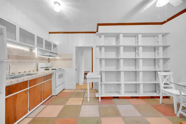 a living room with a table and paintings on the wall