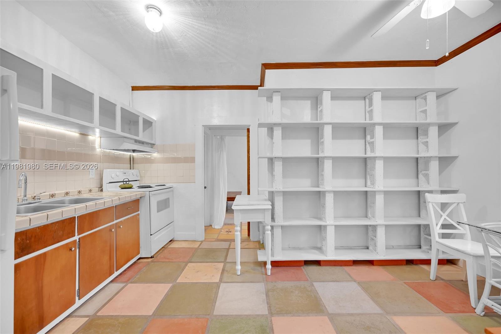 528 Northwest 47th Street, Unit 2 Miami, FL 33127 - Photo 9 of 34 a room with cabinets and view of living room