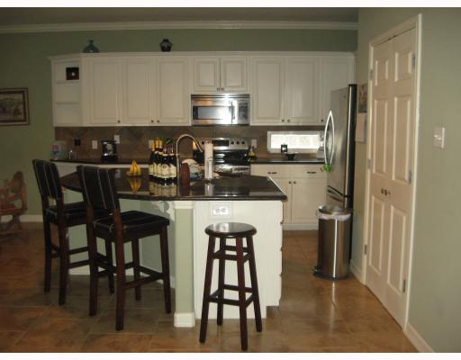3510 Laguna Shores Road Corpus Christi, TX 78418 - Photo 2 of 5 a kitchen with a sink cabinets and refrigerator