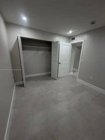 a bathroom with a granite countertop toilet a sink and a bathtub