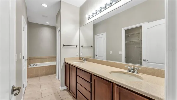 a white bath tub sitting next to a shower