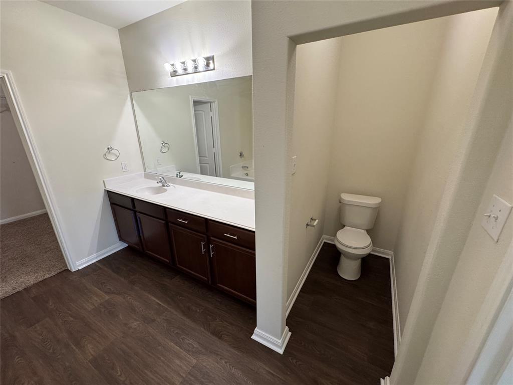 1318 Lucchese Lane Dallas, TX 75253 - Photo 10 of 25 a spacious bathroom with a double vanity sink and a mirror