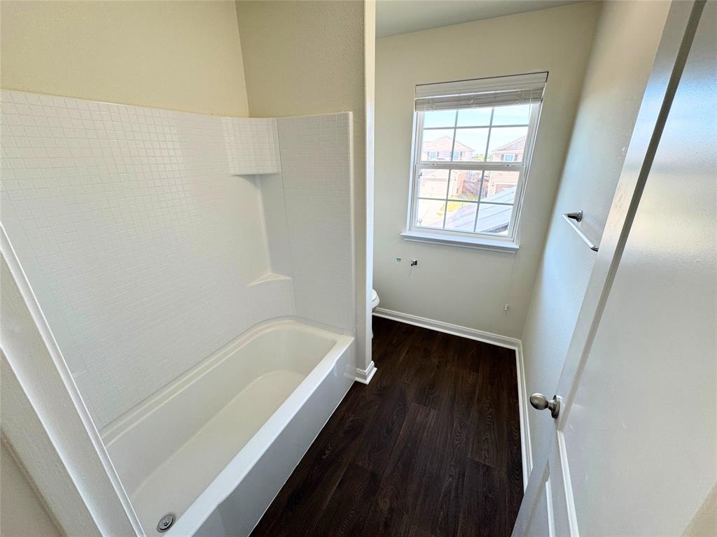 1318 Lucchese Lane Dallas, TX 75253 - Photo 15 of 25 a bathroom with a bathtub and a shower