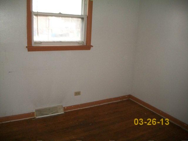 14300 Ridgeway Avenue Midlothian, IL 60445 - Photo 8 of 10 an empty room with wooden floor