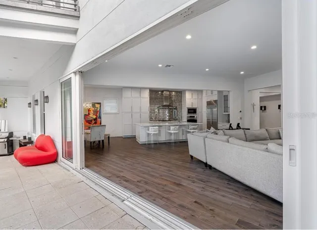 a large white kitchen with sink and cabinets