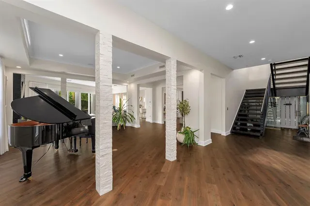 a spacious bedroom with a bed and a chandelier