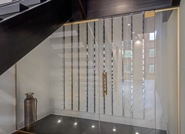 a bedroom with furniture and a large window