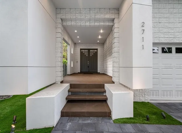 a living room with furniture floor to ceiling window and wooden floor
