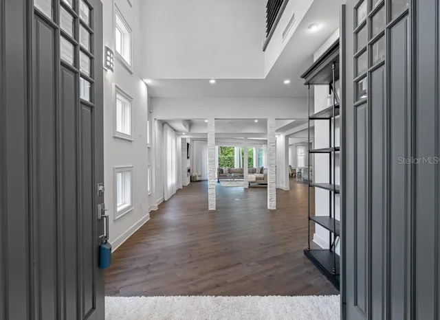 a view of a dining room with furniture wooden floor and chandelier