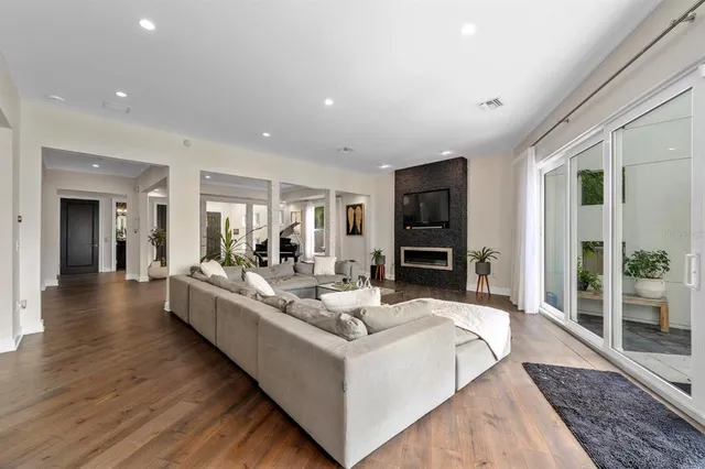 a living room with furniture and kitchen view