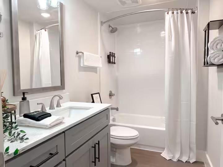 5317 Reiger Avenue, Unit 104 Dallas, TX 75214 - Photo 12 of 13 a bathroom with a sink a toilet and shower