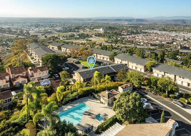 an aerial view of residential houses with outdoor space