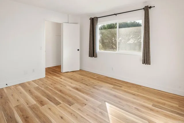 a bedroom with a bed and cabinets