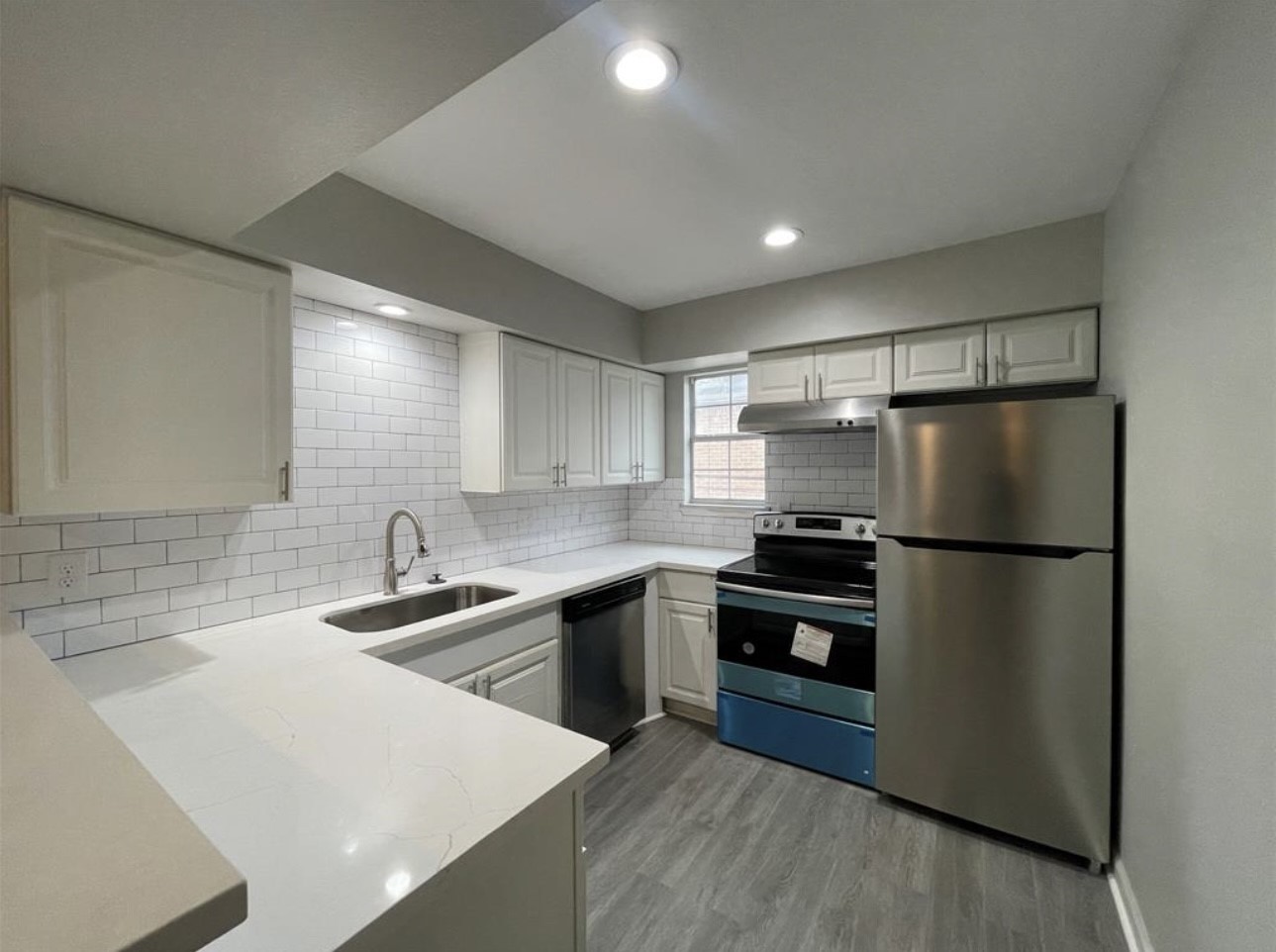 9711 Linkmeadow Lane, Unit 10 Houston, TX 77025 - Photo 1 of 27 a kitchen with kitchen island a sink stainless steel appliances and cabinets