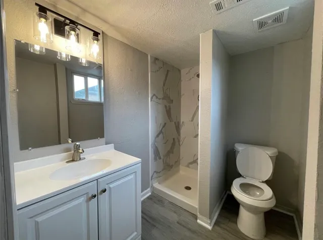 a bathroom with a sink toilet and shower